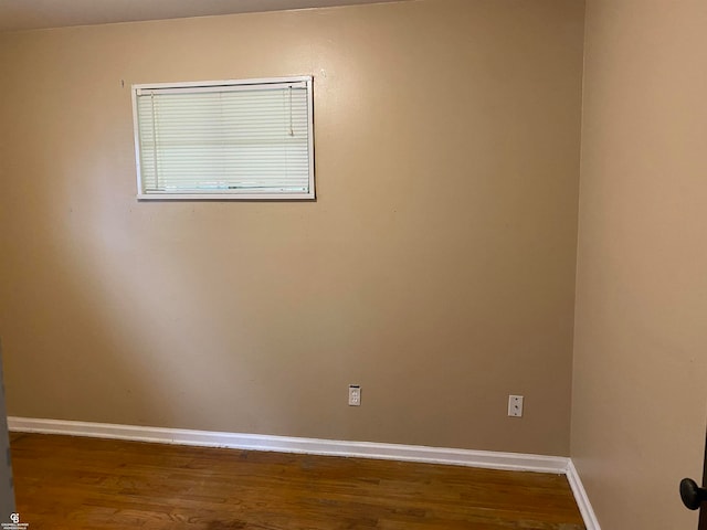 spare room with hardwood / wood-style flooring