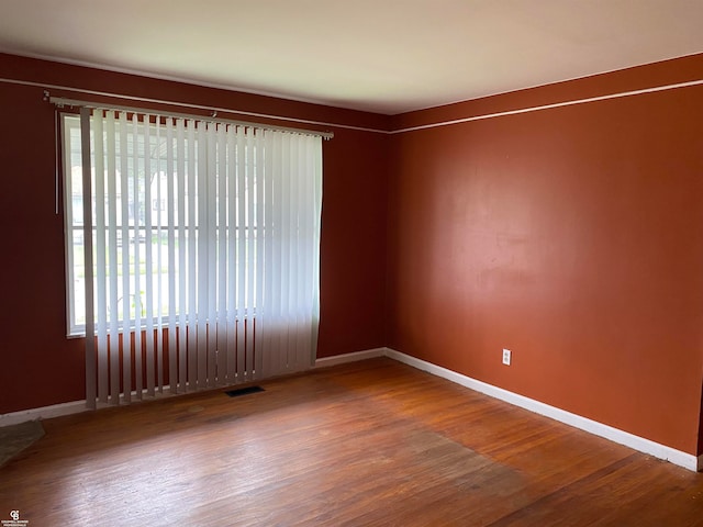 unfurnished room with hardwood / wood-style floors