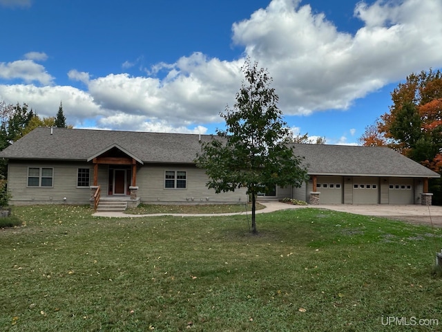 view of front of property with a garage and a front yard