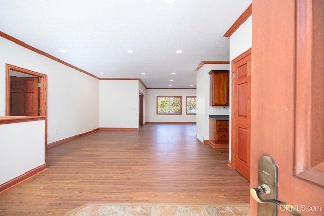 23 Chipman Dr, Ishpeming, MI 49849 - unfurnished living room featuring crown molding, light wood-style floors, recessed lighting, and baseboards