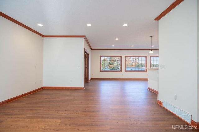23 Chipman Dr, Ishpeming, MI 49849 - unfurnished living room with ornamental molding, wood finished floors, recessed lighting, and baseboards