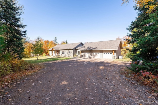 23 Chipman Dr, Ishpeming, MI 49849 - ranch-style house featuring dirt driveway and a garage