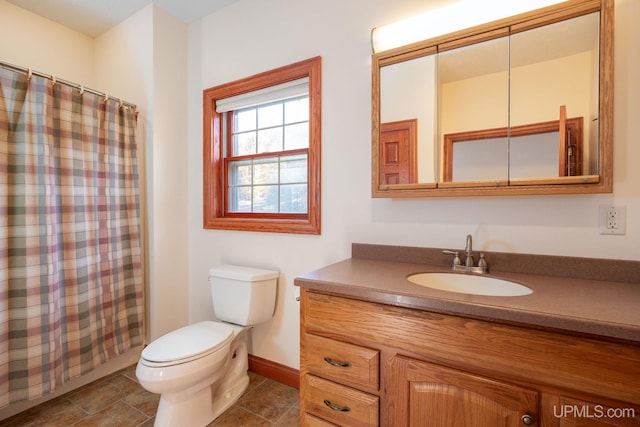 23 Chipman Dr, Ishpeming, MI 49849 - bathroom with vanity, toilet, baseboards, and a shower with shower curtain