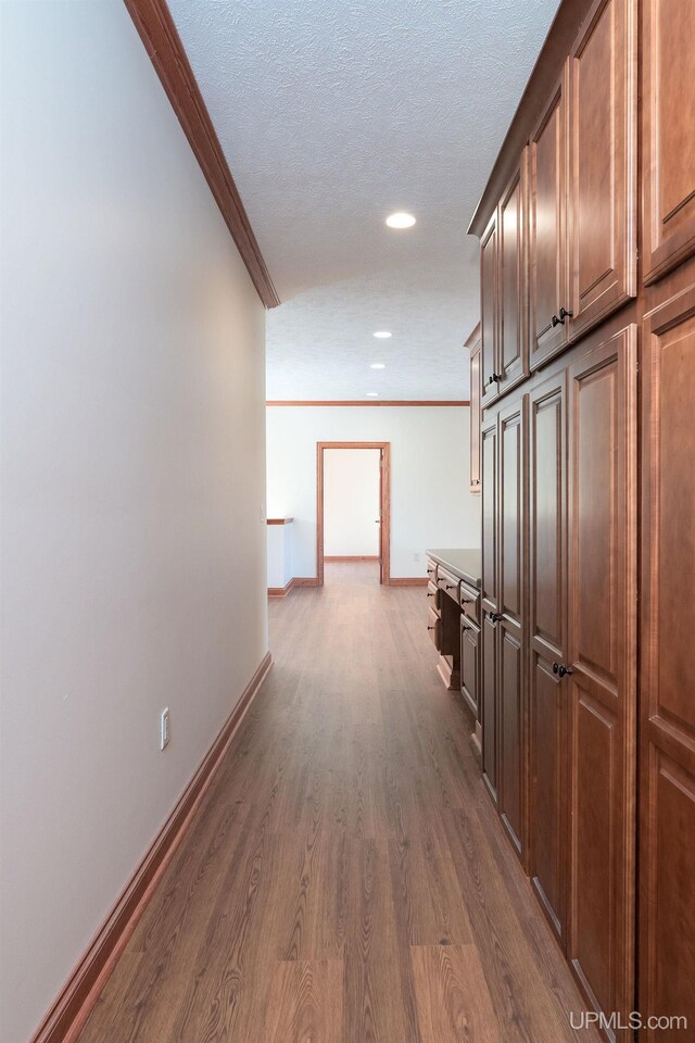 23 Chipman Dr, Ishpeming, MI 49849 - hall featuring crown molding, dark wood-type flooring, recessed lighting, baseboards, and a textured ceiling
