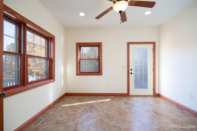 23 Chipman Dr, Ishpeming, MI 49849 - unfurnished room featuring healthy amount of natural light, baseboards, recessed lighting, stone finish flooring, and ceiling fan