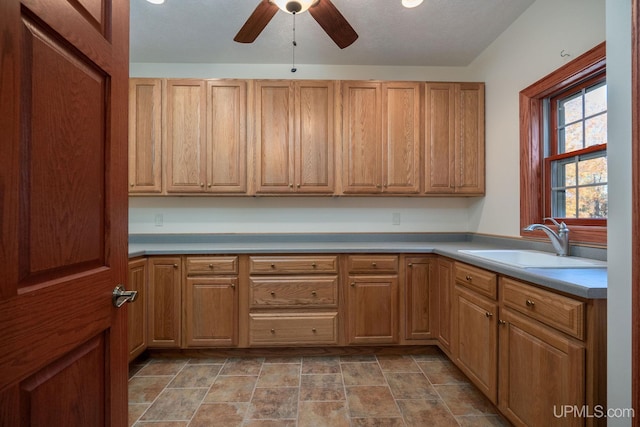 23 Chipman Dr, Ishpeming, MI 49849 - kitchen featuring a sink, ceiling fan, stone finish floors, and light countertops