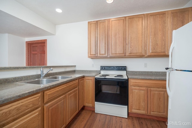 23 Chipman Dr, Ishpeming, MI 49849 - kitchen with freestanding refrigerator, range with electric cooktop, a sink, dark wood-type flooring, and recessed lighting