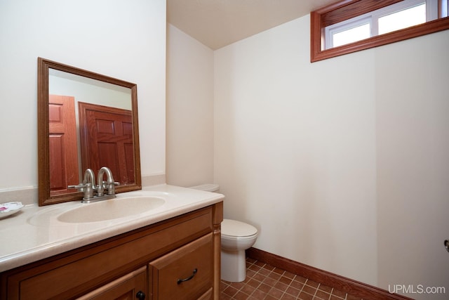 23 Chipman Dr, Ishpeming, MI 49849 - bathroom with vanity, toilet, and baseboards
