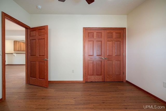 23 Chipman Dr, Ishpeming, MI 49849 - unfurnished bedroom featuring wood finished floors, baseboards, and ceiling fan