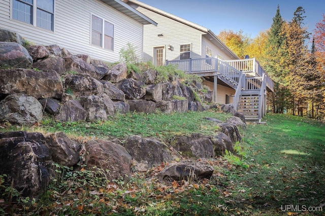 23 Chipman Dr, Ishpeming, MI 49849 - back of house featuring stairway, a wooden deck, and a lawn