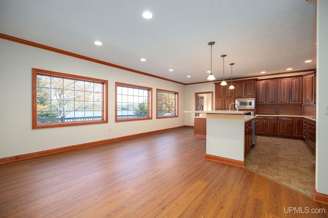 23 Chipman Dr, Ishpeming, MI 49849 - kitchen featuring healthy amount of natural light, light countertops, recessed lighting, light wood-style floors, and baseboards