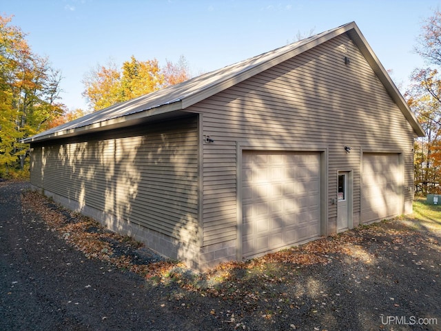 23 Chipman Dr, Ishpeming, MI 49849 - view of home's exterior with a detached garage and an outdoor structure