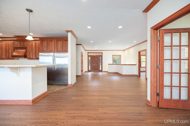 23 Chipman Dr, Ishpeming, MI 49849 - kitchen featuring freestanding refrigerator, ornamental molding, wood finished floors, baseboards, and recessed lighting