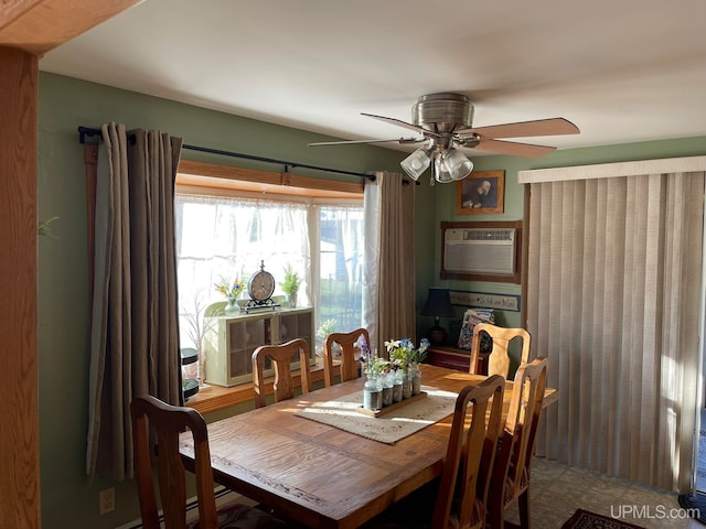 dining room with ceiling fan and a wall unit AC