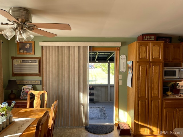 interior space featuring ceiling fan and a wall unit AC