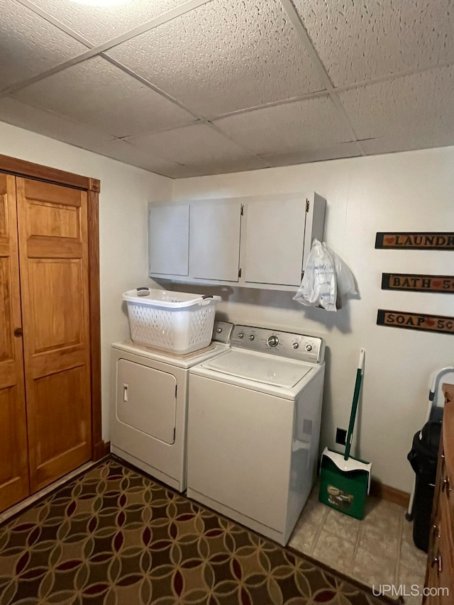 laundry area with washer and clothes dryer and cabinets