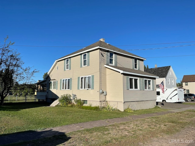 view of side of home with a lawn