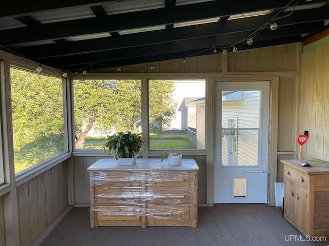 sunroom / solarium featuring vaulted ceiling