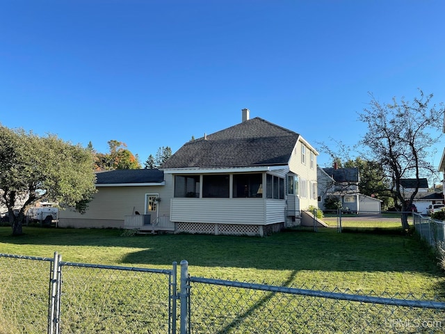 view of front of house with a front lawn and a sunroom