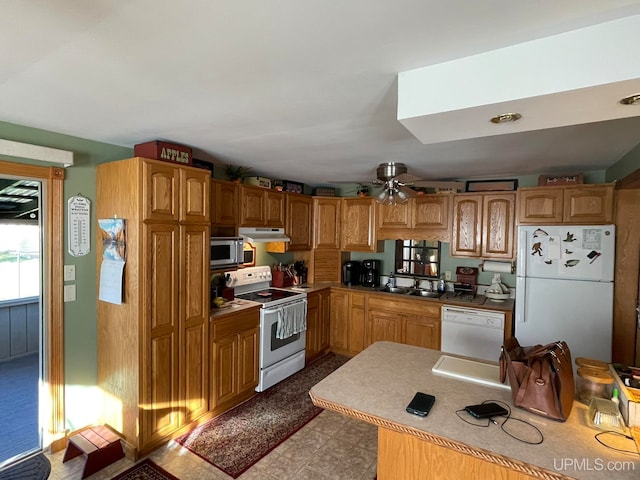 kitchen featuring white appliances, sink, and ceiling fan