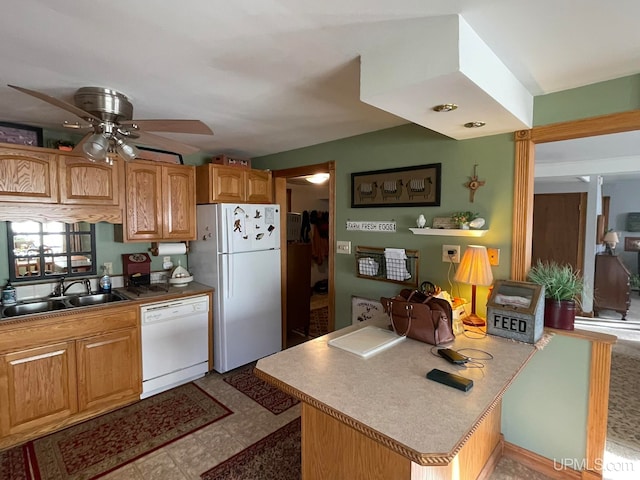 kitchen featuring ceiling fan, sink, and white appliances