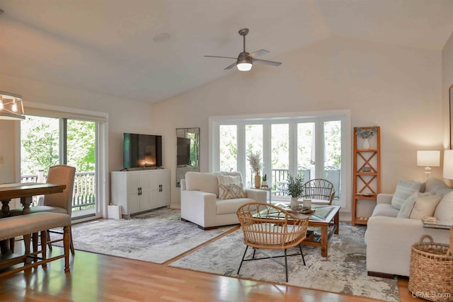 living room featuring a wealth of natural light, ceiling fan, high vaulted ceiling, and hardwood / wood-style flooring