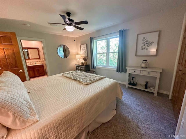 carpeted bedroom featuring ceiling fan and ensuite bathroom