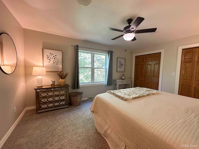 carpeted bedroom featuring a closet, a textured ceiling, and ceiling fan