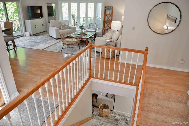 stairway featuring wood-type flooring and plenty of natural light