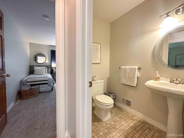 bathroom featuring tile patterned floors, toilet, and sink