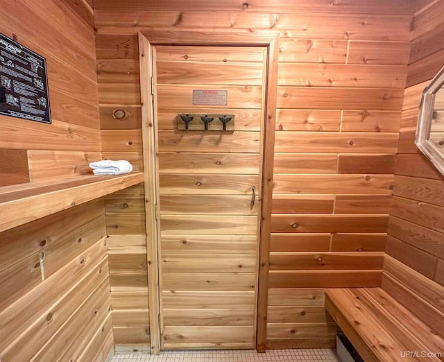 view of sauna with wooden walls