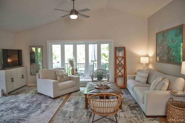 living room with hardwood / wood-style flooring, ceiling fan, and vaulted ceiling