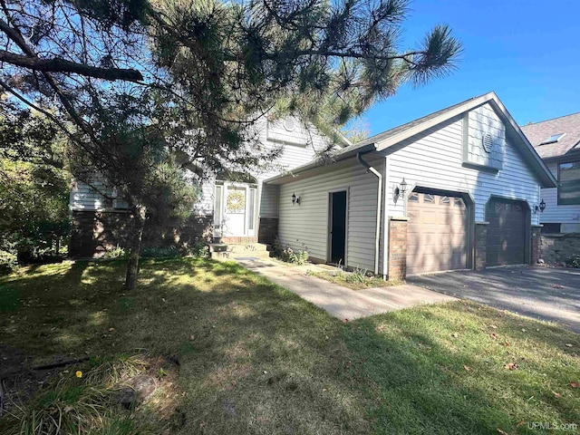 exterior space with a garage and a lawn