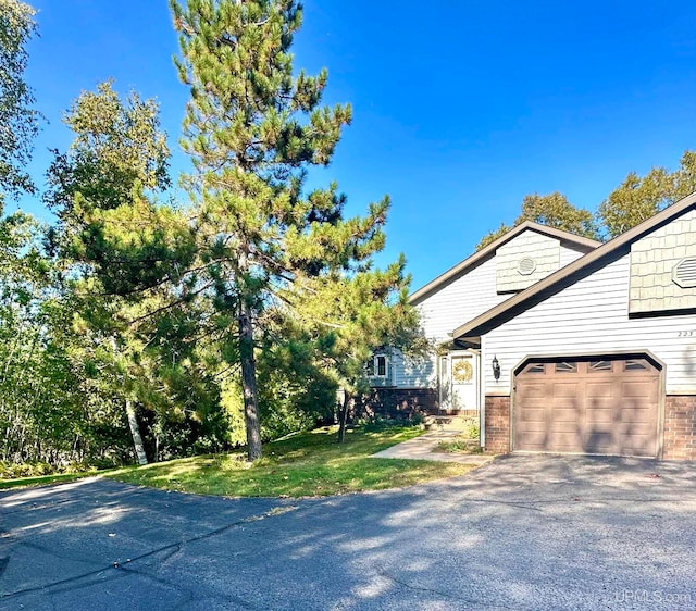 view of property exterior featuring a garage and a yard