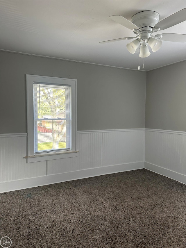 carpeted spare room with ceiling fan