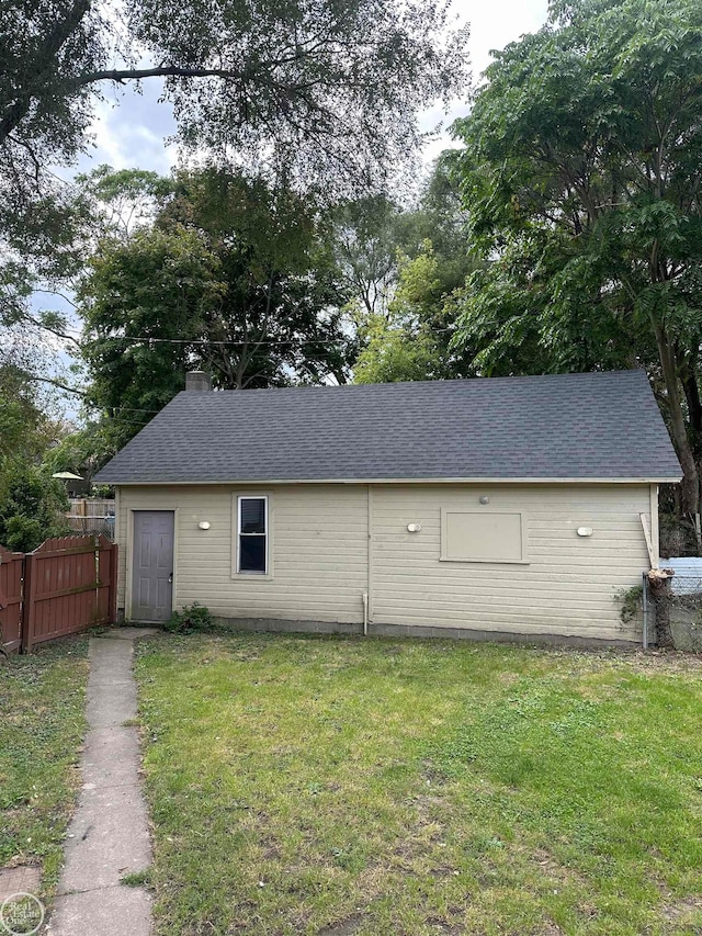 view of outbuilding featuring a lawn