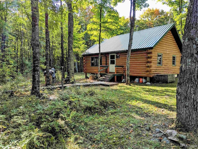 rear view of house featuring a lawn