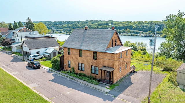 birds eye view of property with a water view