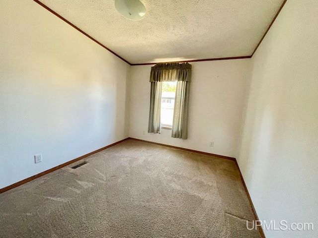 carpeted spare room featuring a textured ceiling and crown molding