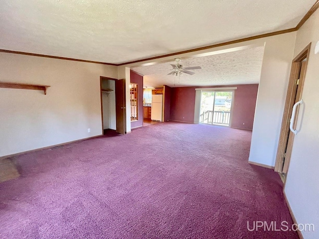 unfurnished living room featuring ceiling fan, ornamental molding, a textured ceiling, and carpet flooring