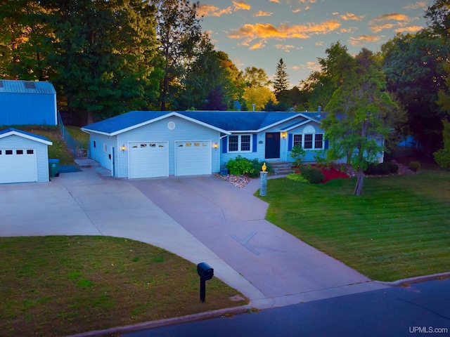 single story home featuring an outdoor structure and a yard