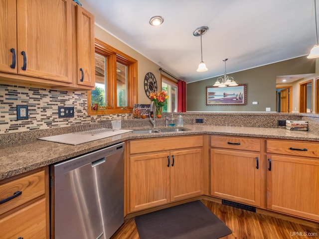 kitchen with light stone countertops, pendant lighting, dark hardwood / wood-style flooring, stainless steel dishwasher, and sink