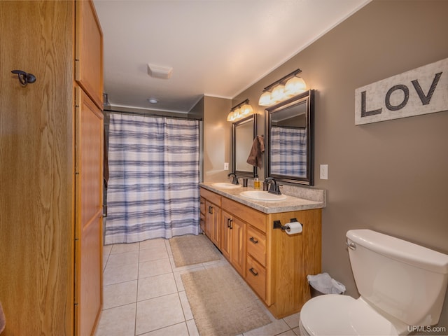 bathroom featuring tile patterned flooring, vanity, and toilet