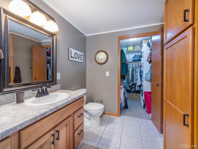 bathroom featuring vanity, toilet, and tile patterned floors