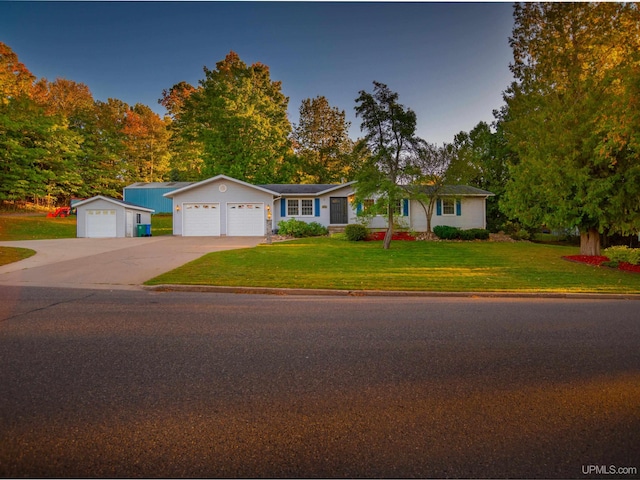 ranch-style home featuring a front lawn and a garage