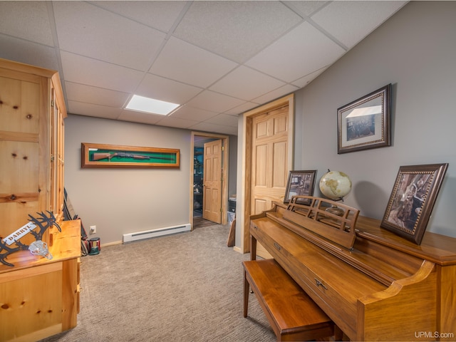 miscellaneous room with carpet floors, a drop ceiling, and a baseboard heating unit