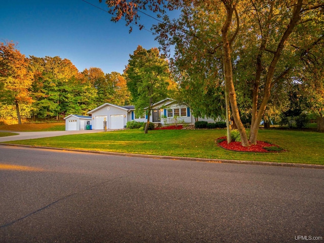 view of front of property featuring a garage and a front lawn