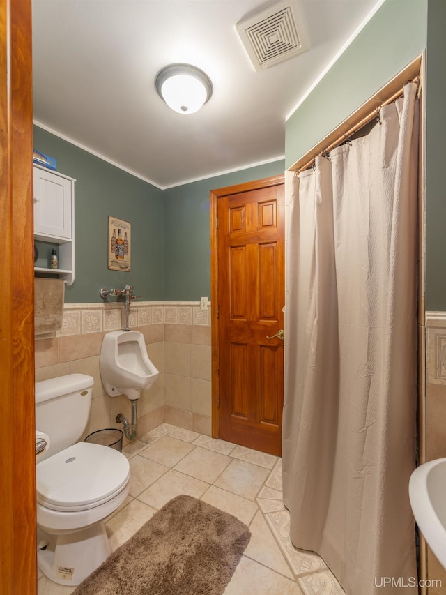 bathroom featuring tile walls, sink, tile patterned floors, and toilet