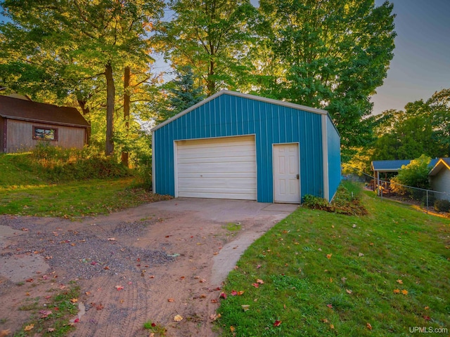 garage at dusk with a lawn