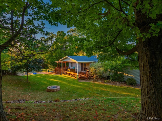 view of yard featuring a fire pit and a deck